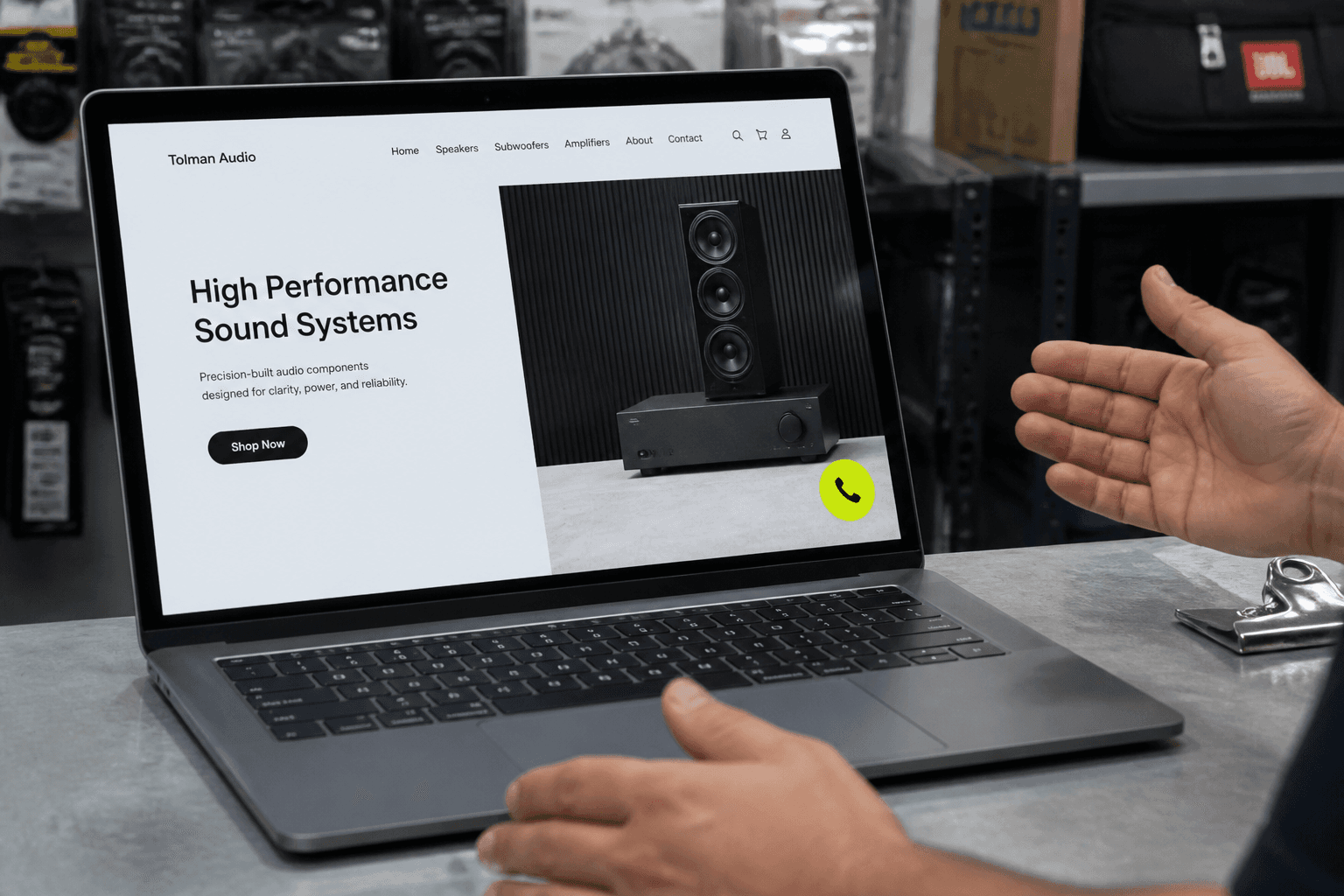 Shop counter laptop showing a website with a lime voice button